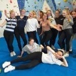 Year 10 Geography Group at Calshot Activities Centre in front of a climbing wall.