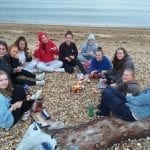 Year 10 Geography group at Calshot beach enjoying marshmallows.